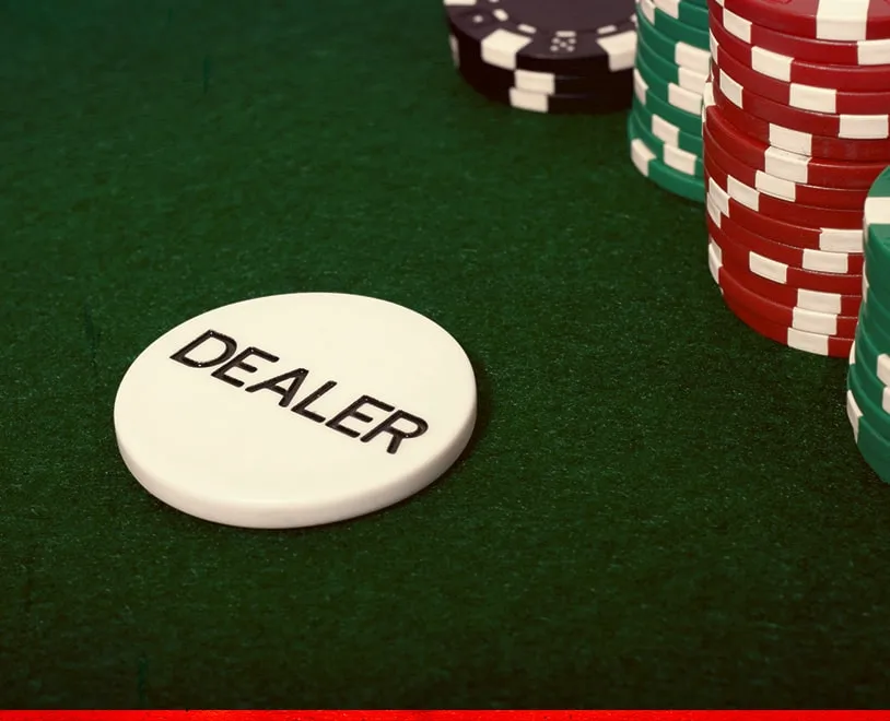 Dealer Button chip among other poker chips